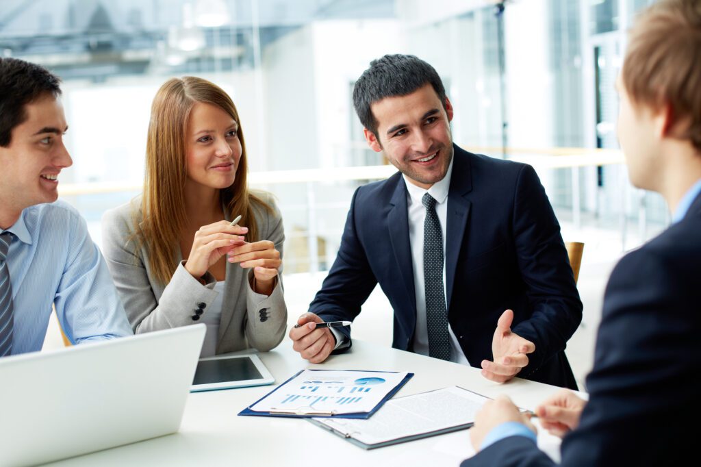 Image of business partners discussing documents and ideas at meeting.